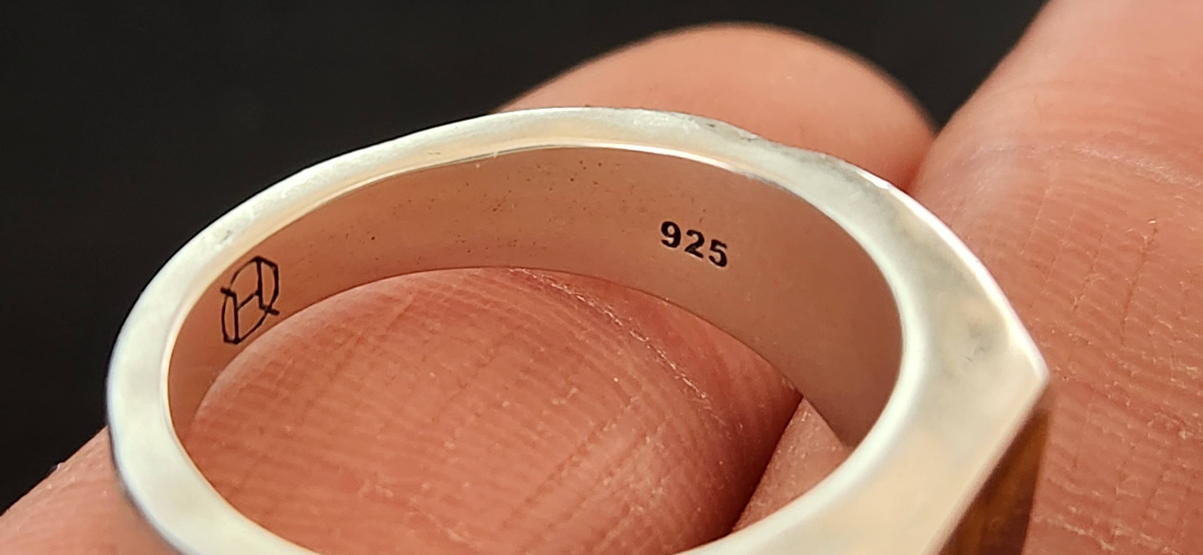 Inside a silver ring band showing the 925 hallmark