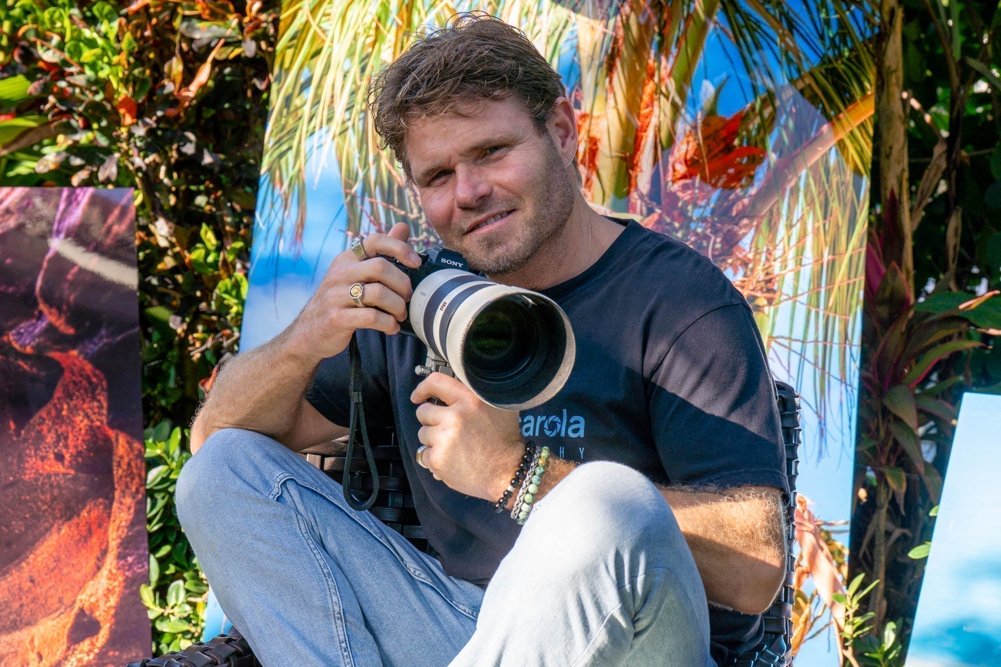 Photographer holding camera in front of colorful background