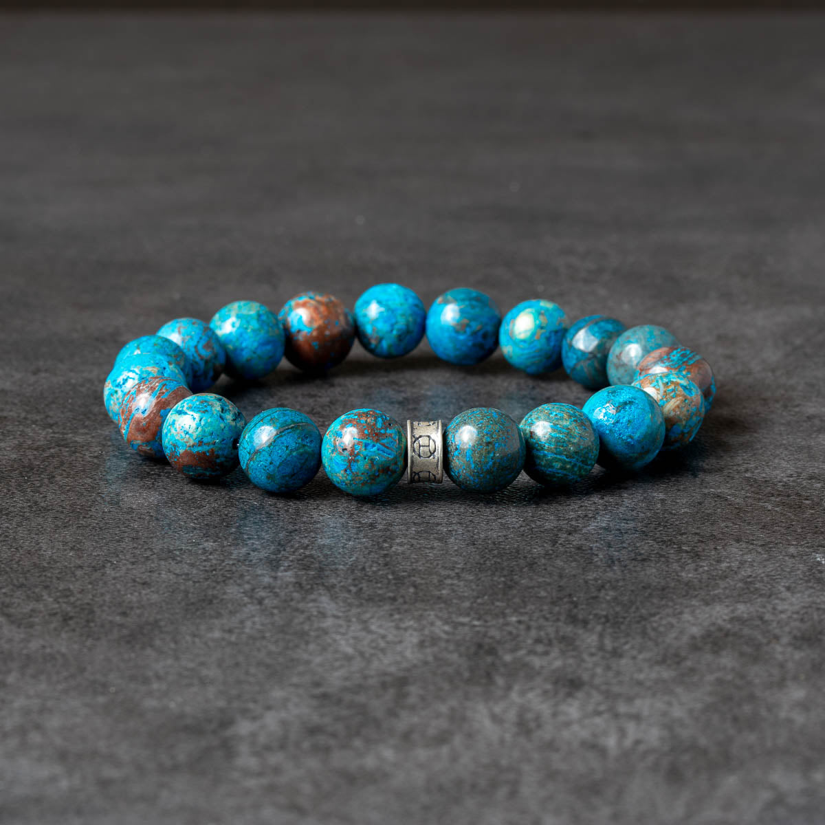 Bluish green beaded bracelet with silver accent bead