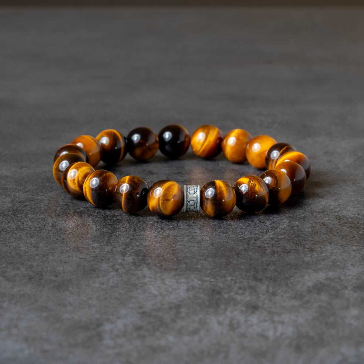Golden brown tiger eye beaded bracelet on gray background