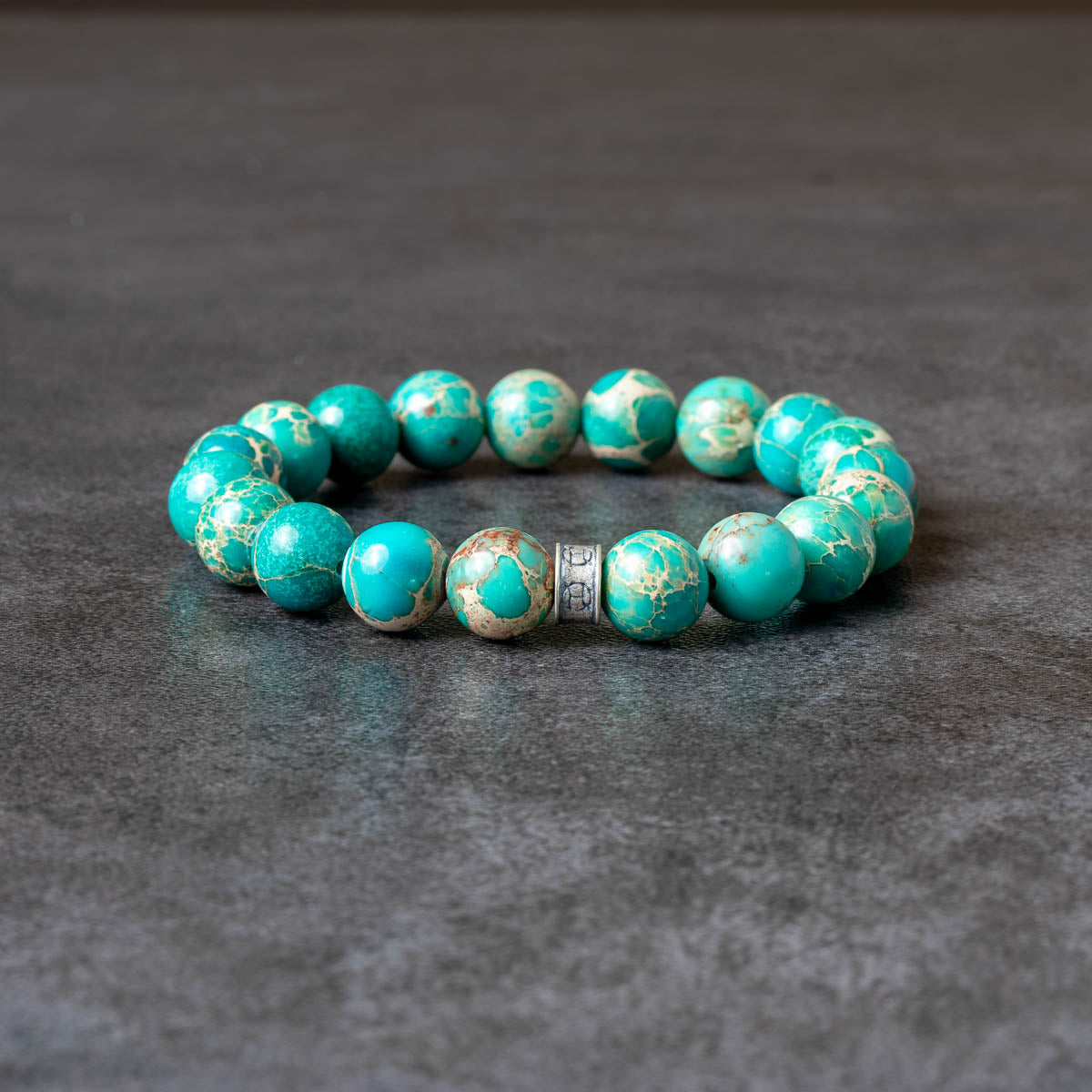 Turquoise beaded bracelet on gray background