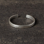 Silver bracelet on a dark textured surface