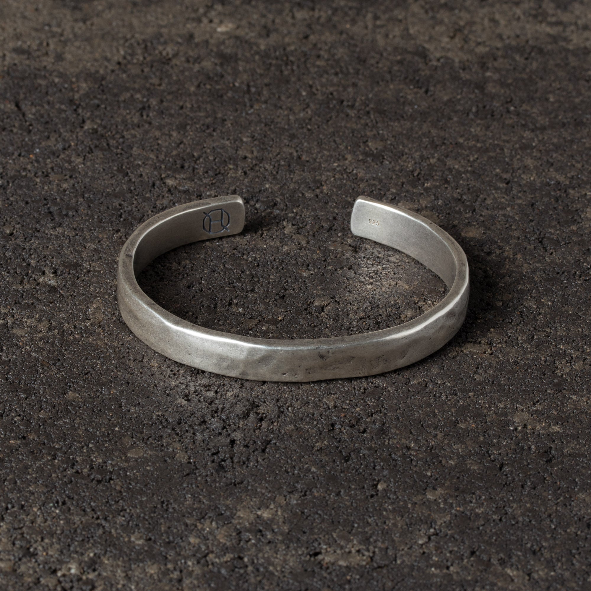 Silver bracelet on a dark textured surface