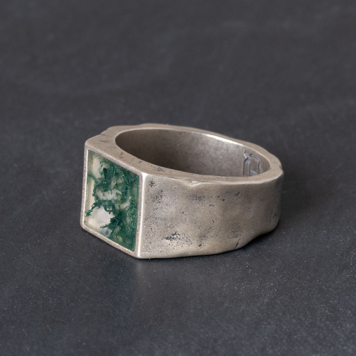Quinn Henry Silver ring with a square moss agate inlay on a dark background
