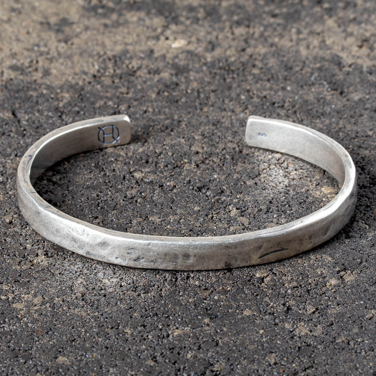 Silver cuff on a dark stone surface
