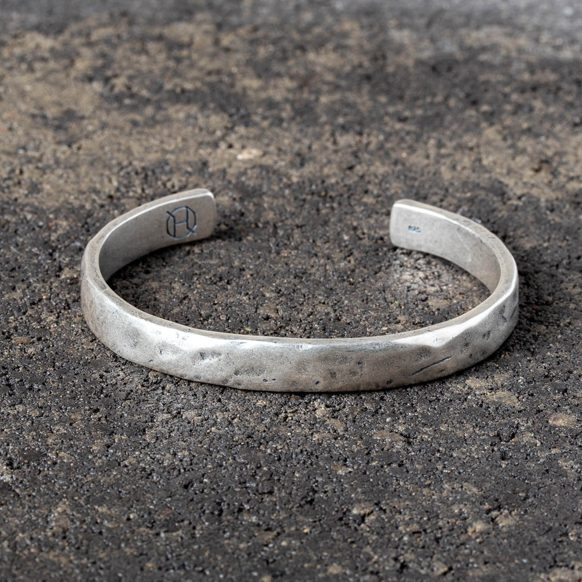 Silver cuff on a textured dark surface
