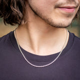 Man in black t-shirt wearing silver box chain