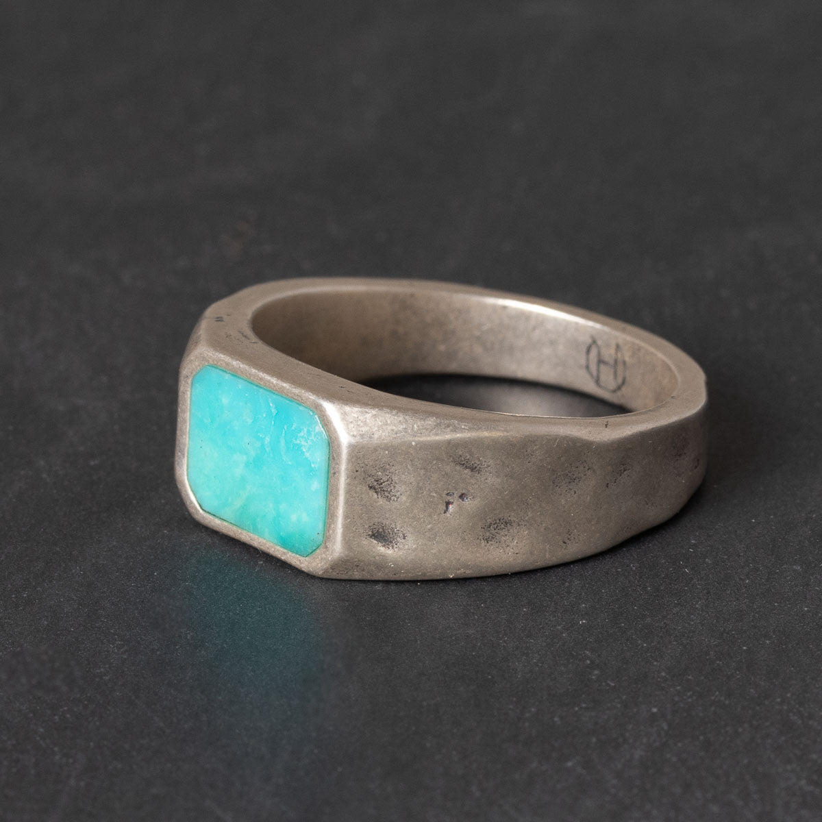 Sterling silver signet ring with a natural turquoise inlay and rugged textured band