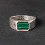 Silver ring with a Malachite  gemstone on a dark gray background