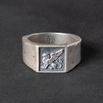 Silver Signet ring with a griffin carving on a dark background