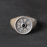 Silver signet ring with a vegvisir design and black onyx stone on a dark background