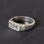 A Quinn Henry Sterling silver signet ring with engraved frog fossil skeleton.