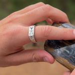Sterling Silver Quinn Henry ring with frog skeleton engraving on a hand
