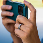 Hand holding a smartphone with a blurred background